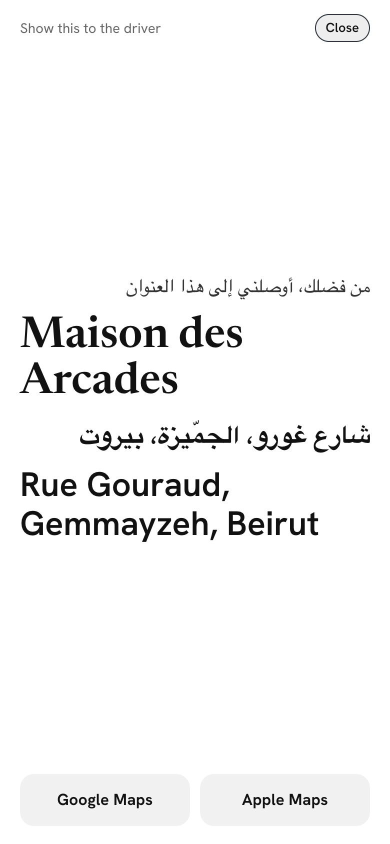 The taxi card, with the address in Arabic